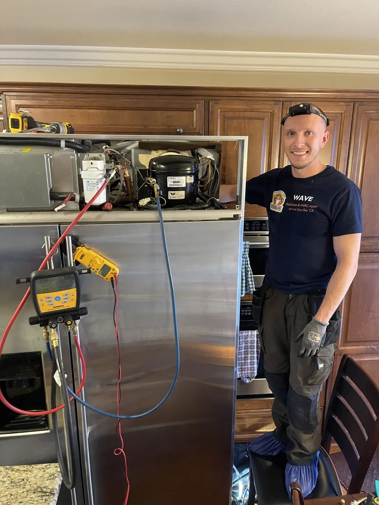 Wave technician working beside a refrigerator